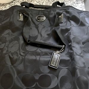 Authentic Coach.  Used but fantastic condition.  Black nylon travel weekender.